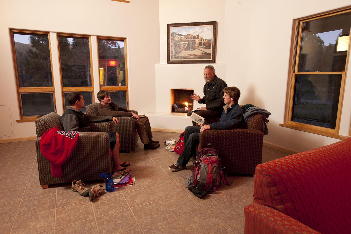 SMU-in-Taos faculty member teaches a small group inside a casita on campus