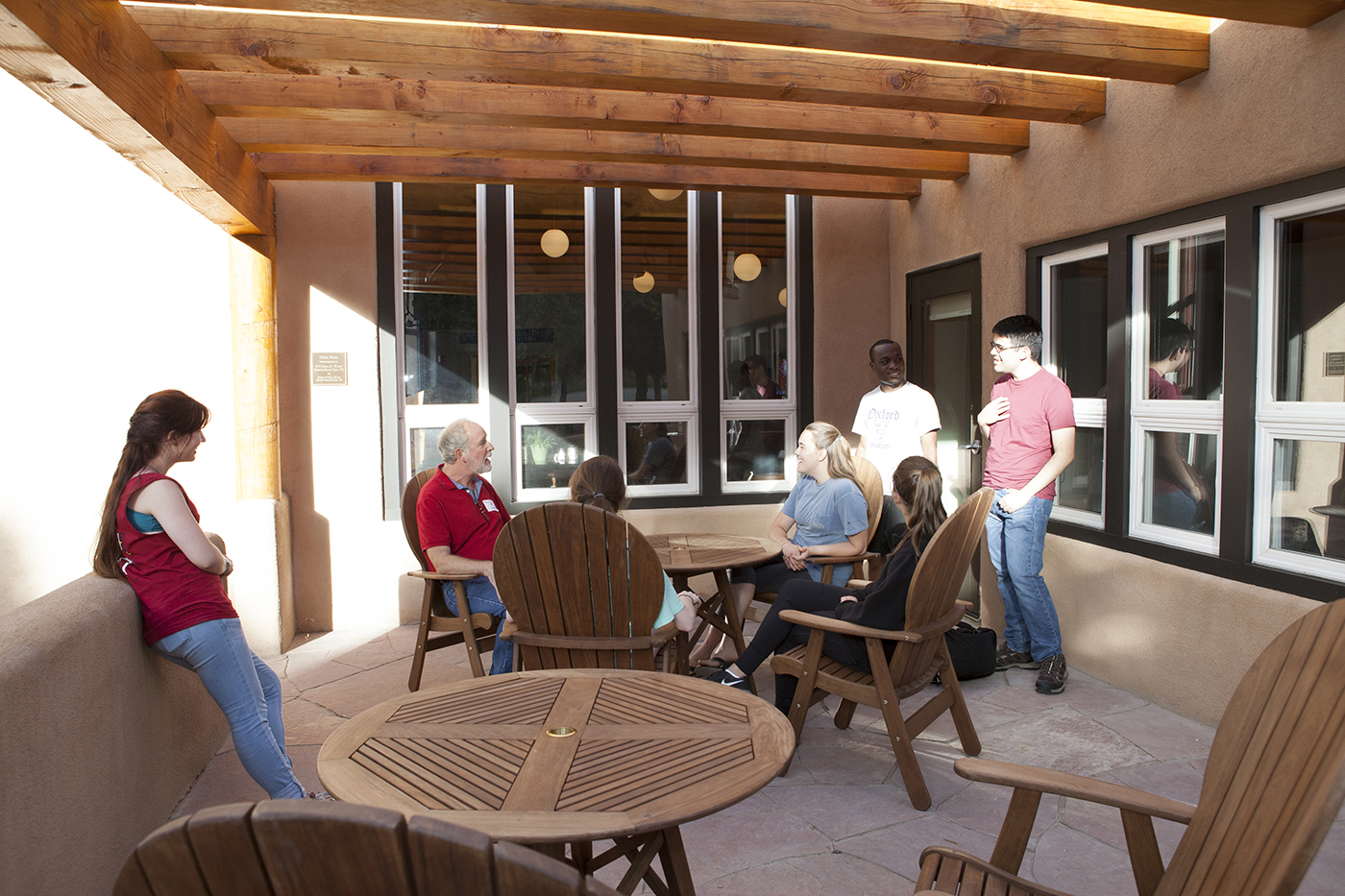 SMU-in-Taos faculty members talk to students on the patio