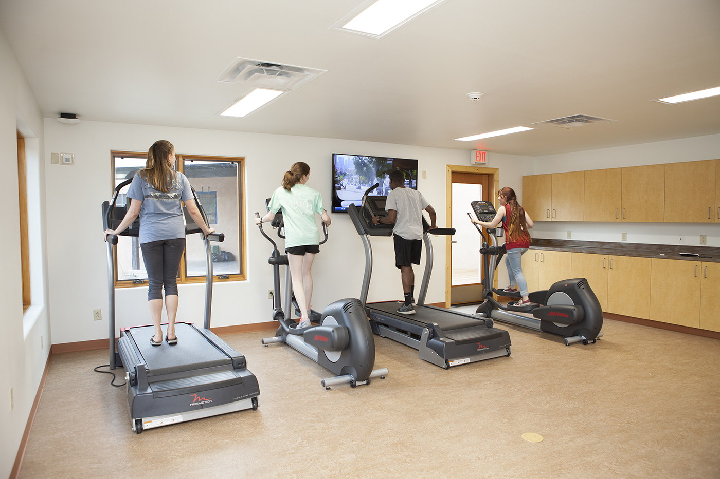 Students work out on treadmills at the the Miller Center at SMU-in-Taos gym.