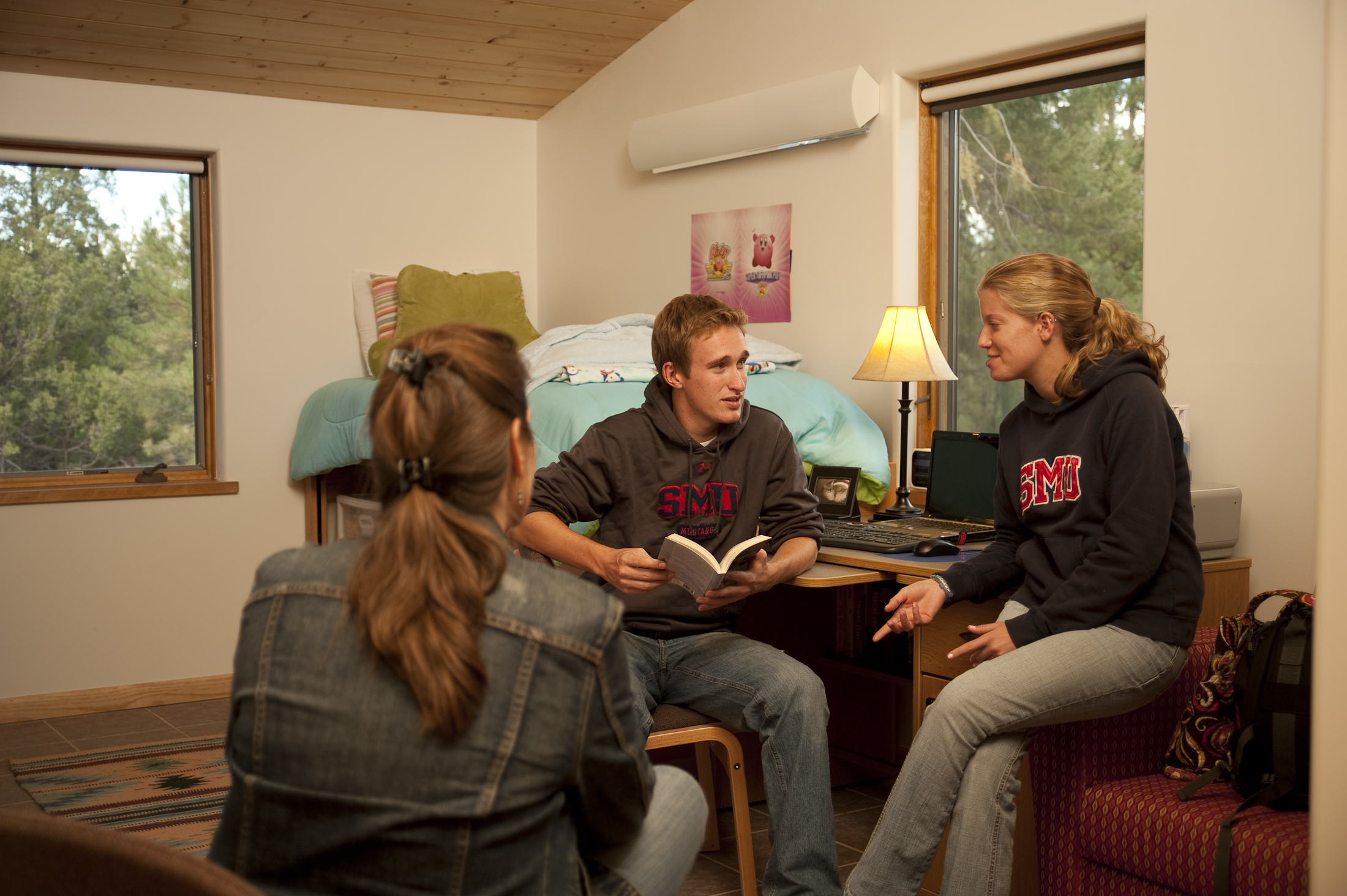 Three students sit and talk in an SMU-in-Taos casita.