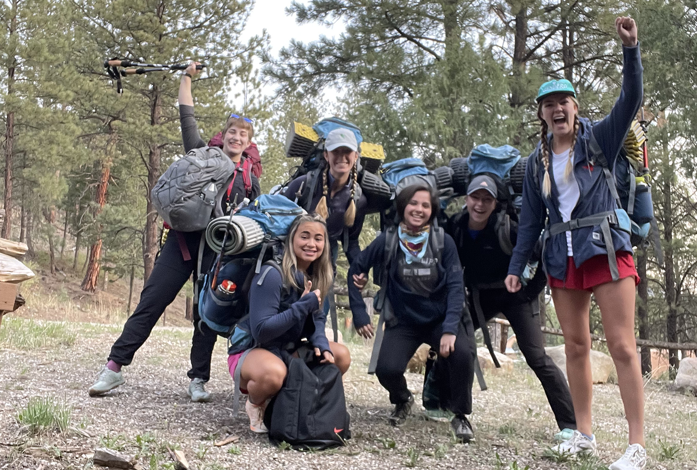 SMU-in-Taos students gathered wearing their backpacks with camping and hiking gear.