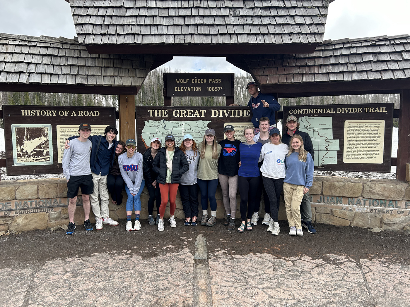 A group of SMU-in-Taos students gather at the Wolf Creek Pass, Continental Divide marker