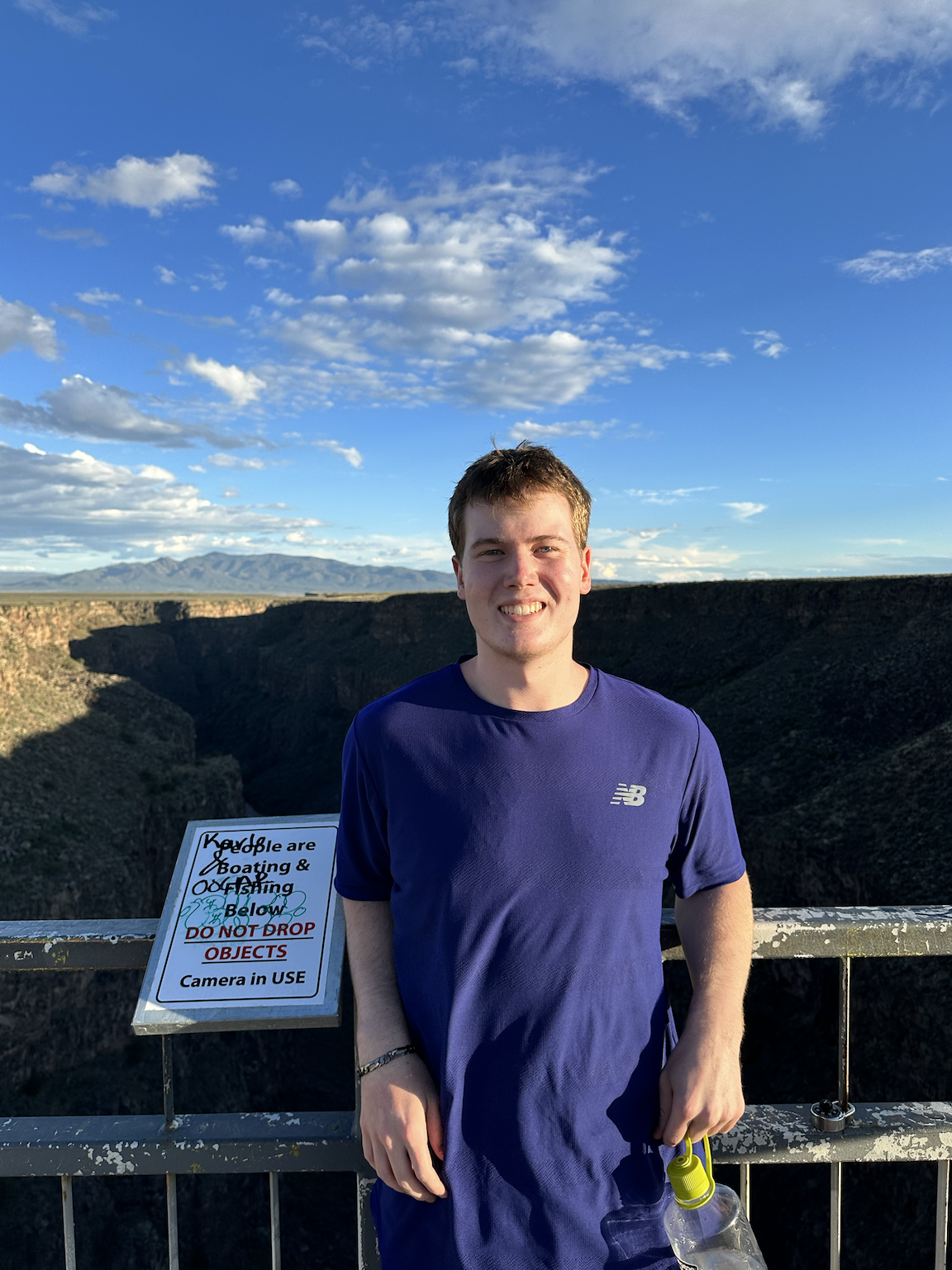 SMU-in-Taos student Nate Stelling stops on the bridge across the Rio Grande Gorge in Taos, NM.