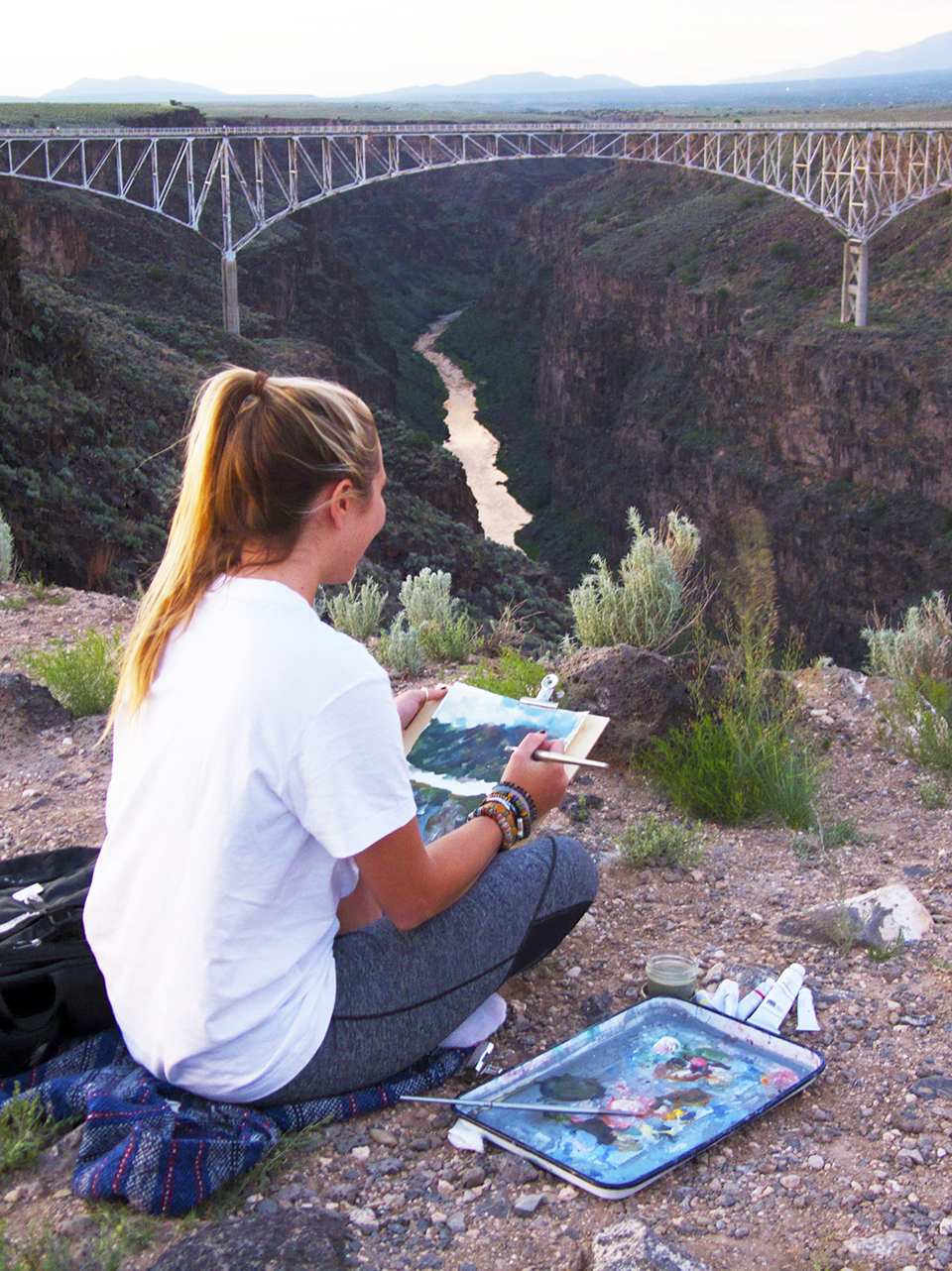 And SMU-in-Taos student sits on the rim of a canyon and paints a bridge.