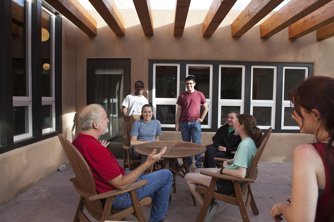 Students listen to an SMU-in-Taos professor as they hold class on the patio of a casita. 