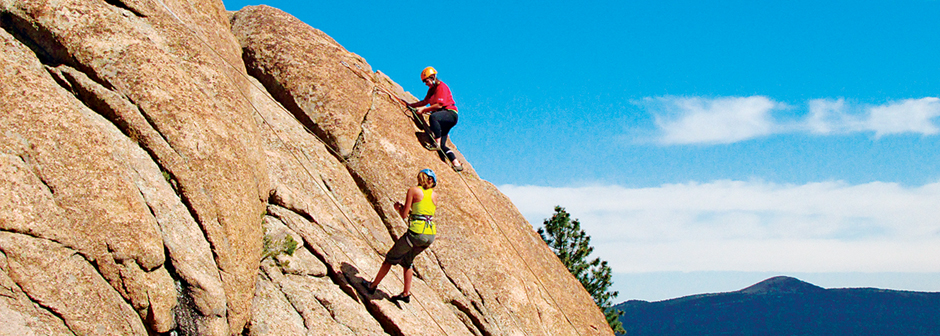 SMU-in-Taos students climb rocks in full climbing gear.