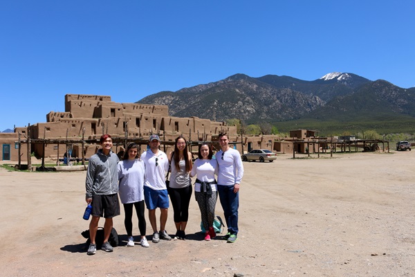 students in front of taos pueblos
