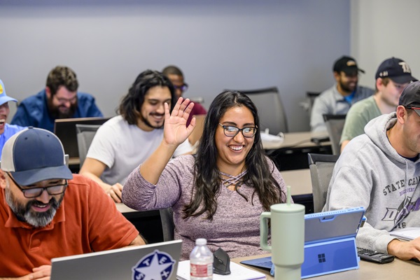 Student raises their hand, engaged in learning at the Lyle School of Engineering at SMU in Dallas.