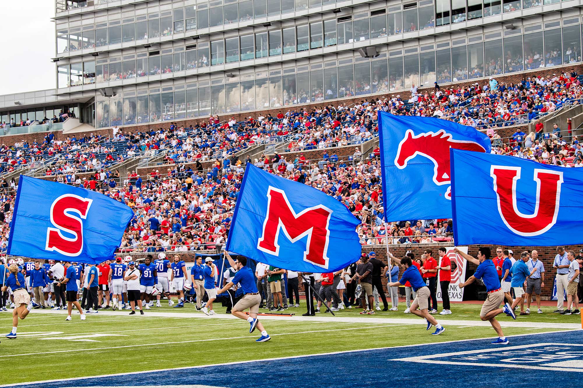 People running with SMU flags