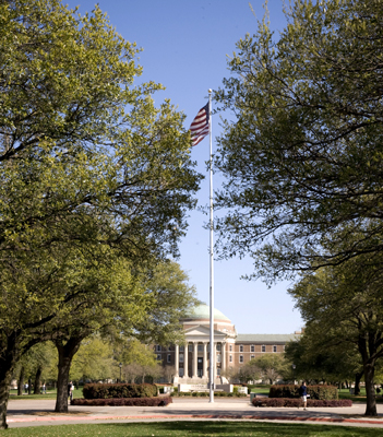 Dallas Hall with American flag in the foreground