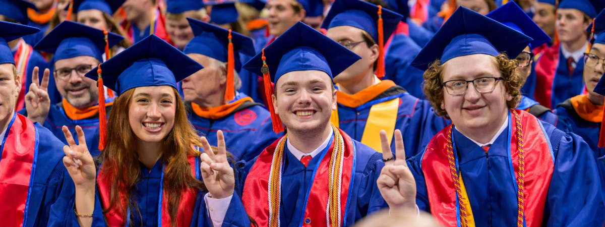 SMU Lyle graduate do the Pony Up hand signal at graduation in 2026