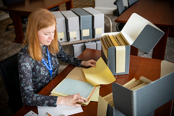 an SMU student engages in hands-on learning at a desk, representing Curricular Practical Training for Undergraduates.