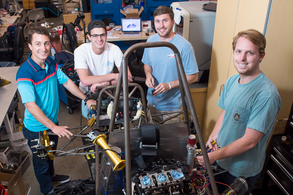 Group of students working together in a workshop on a mechanical project.