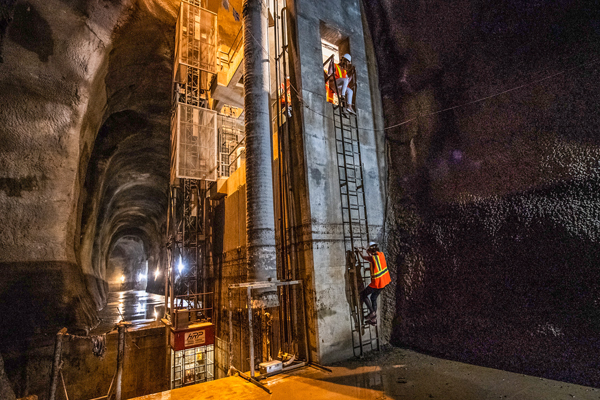Students at SMU Lyle decend a ladder underground in safety gear