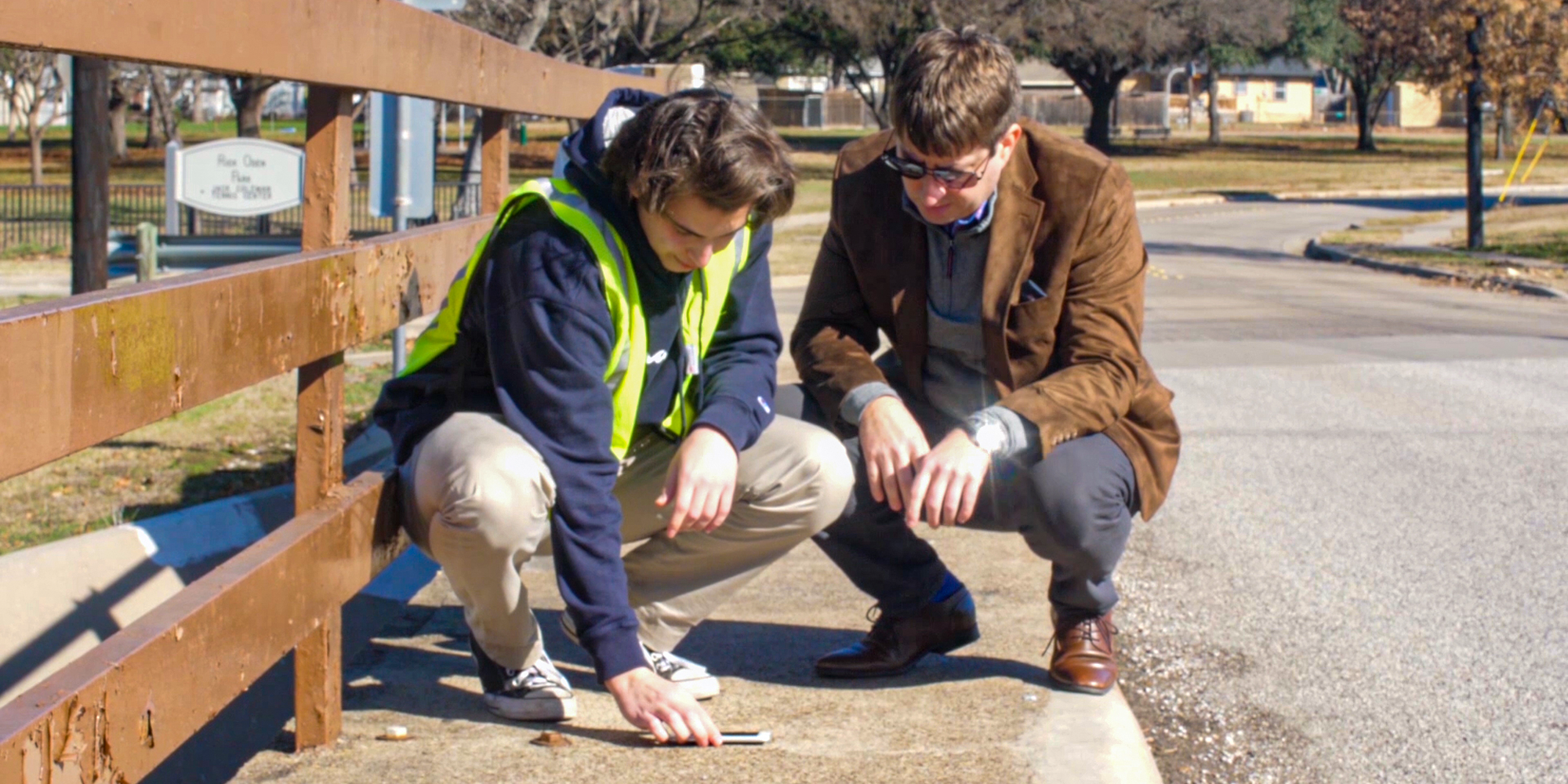 Undergraduate students conducting field research near a walkway