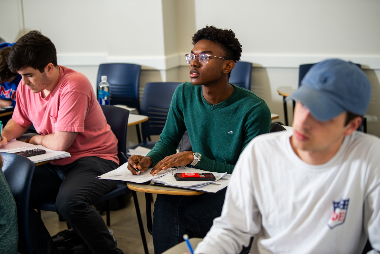 Students sit at desks in class