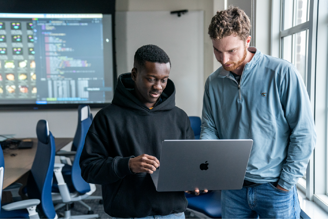 Two students study a computer together