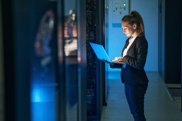 Adobe Stock image of female engineer working in server room at modern data center