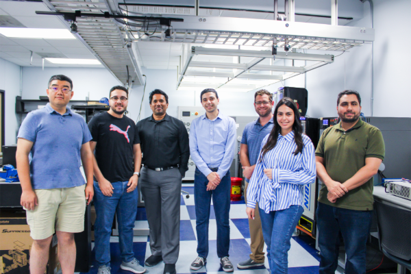 Students and faculty stand together in a lab at SMU Lyle School of Engineering
