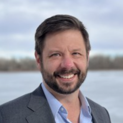 A portrait headshot of Patrick Raney