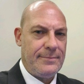 A portrait headshot of Craig Watkins