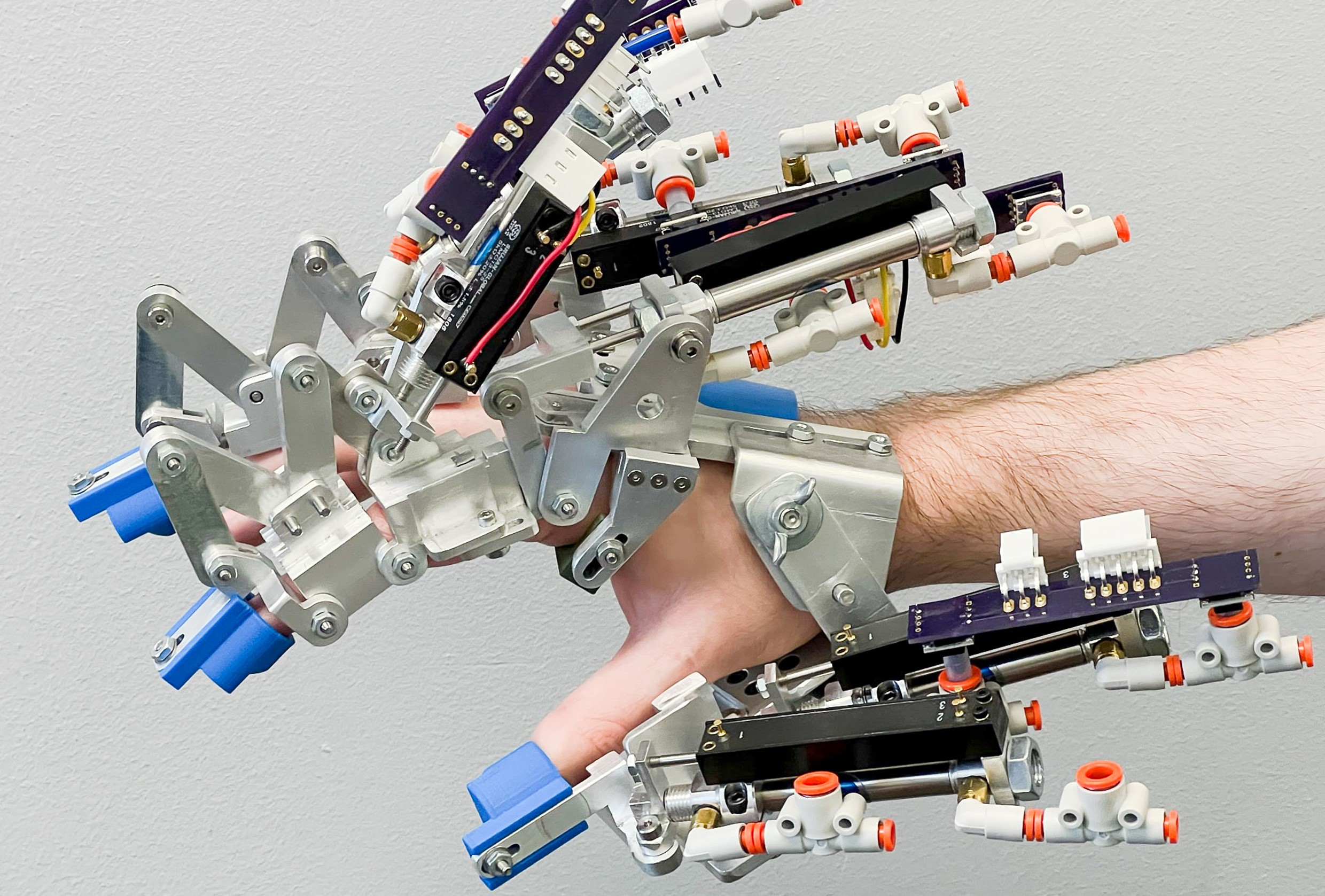 A mans hand covered with robotic components 