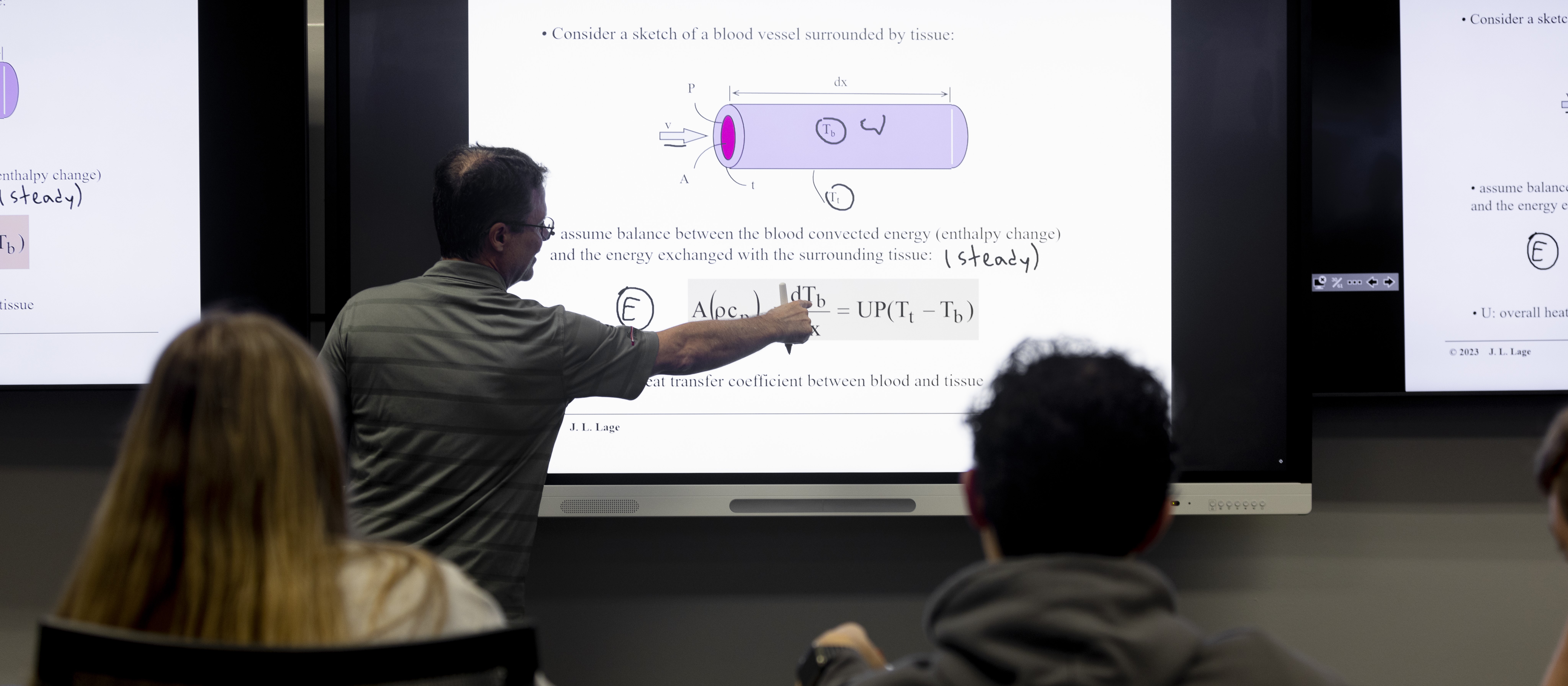 Professor explaining a blood vessel energy transfer diagram to students during an engineering class at SMU Lyle School of Engineering.