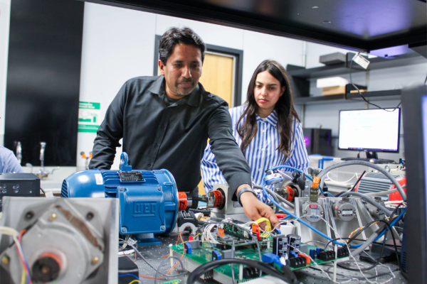 Dr. Mahesh Krishnamurthy stands with a student in his lab at SMU Lyle