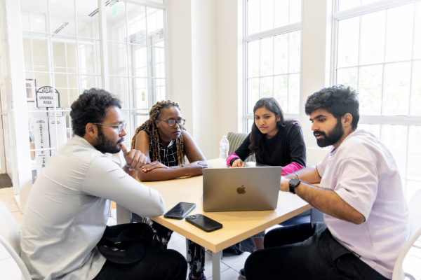 A group of SMU Lyle graduate students work together on a project. 