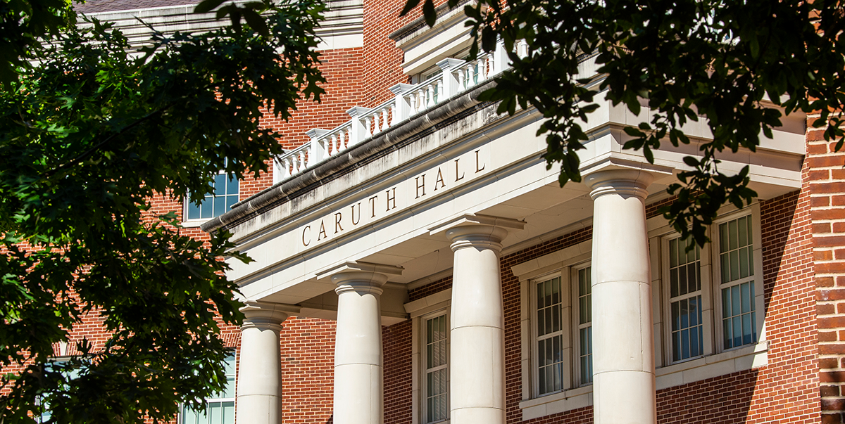Image of young students working at a desk with iPad, laptop, and radio controller.