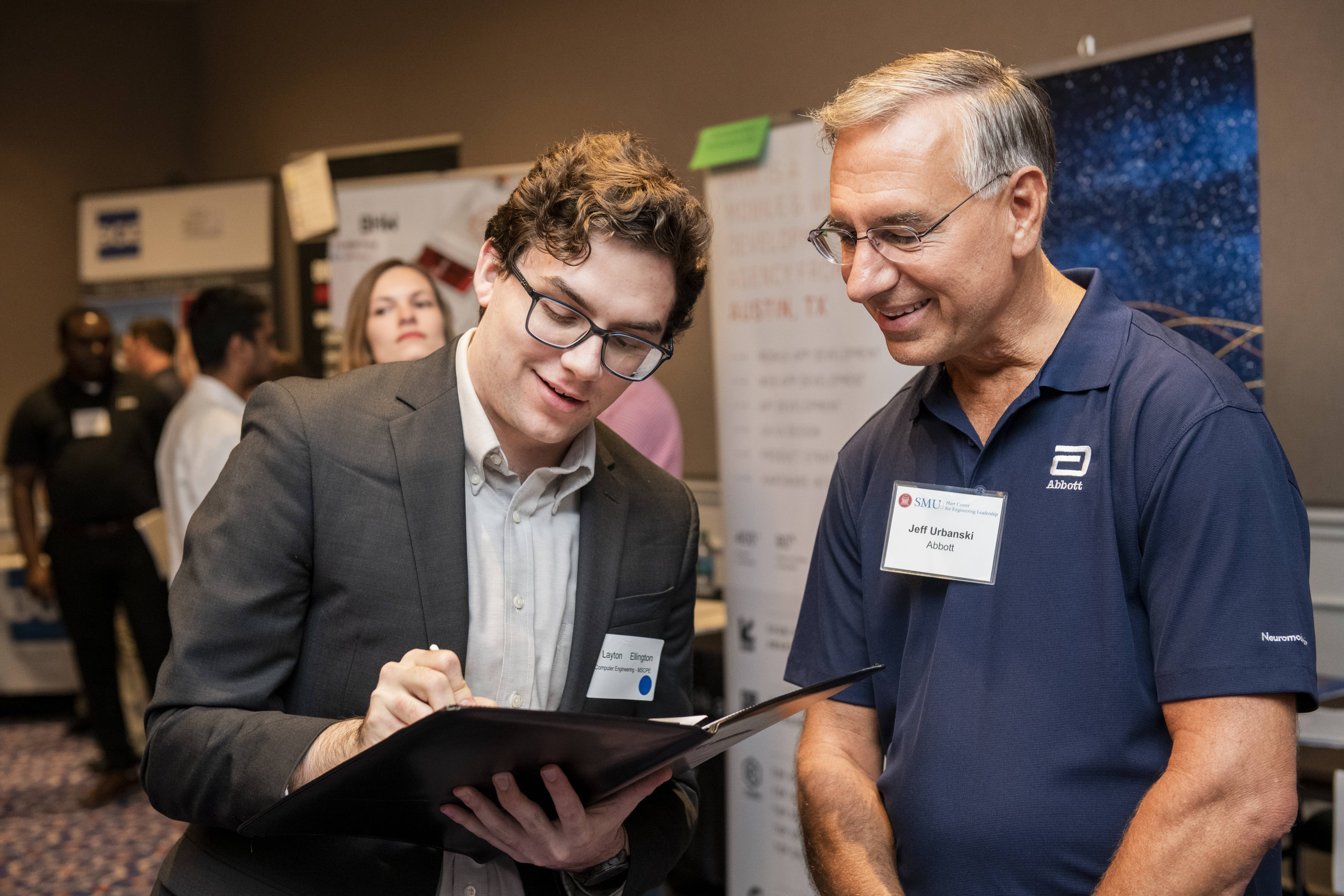 A student speaking with an employer representative at a career fair event 
