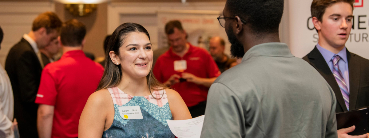 Civil engineering student at SMU speaks with a potential employer at SMU Lyle job fair event