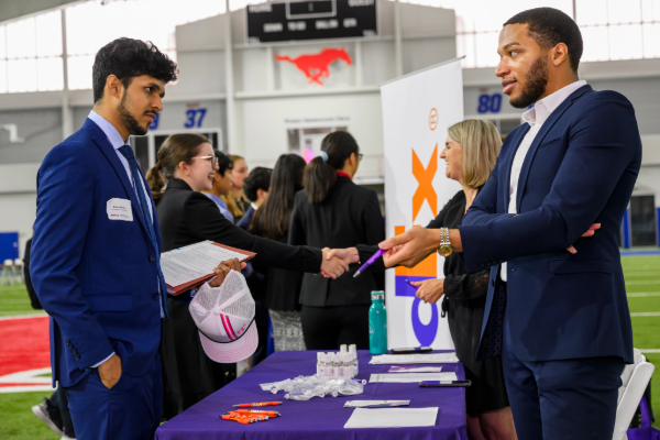 An employer talks to a student at the SMU all majors career fair