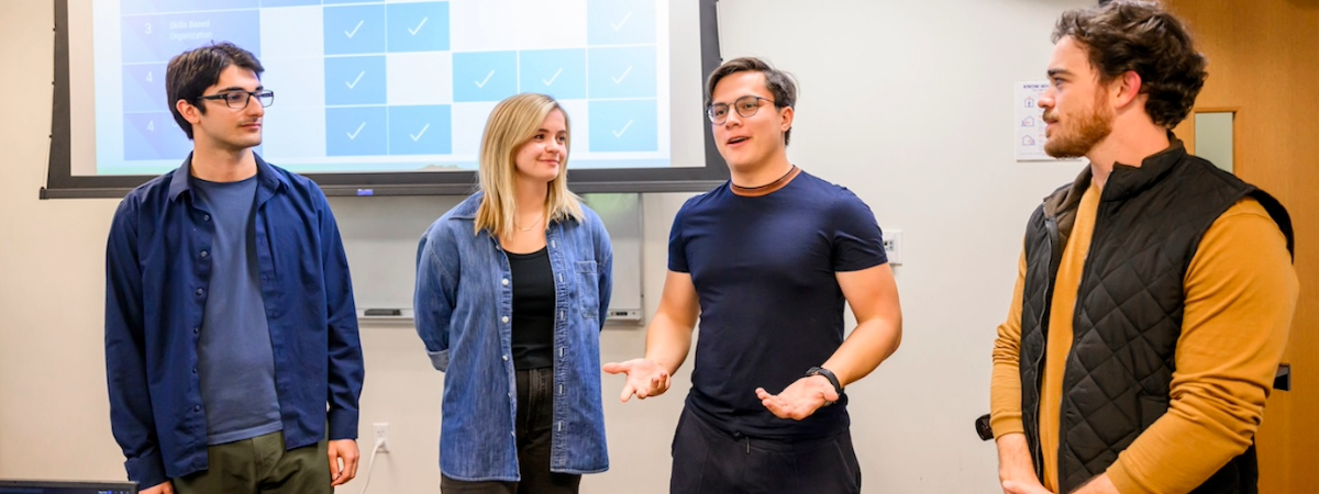 Students present a group project in the SMU Lyle Weekend Format cohort