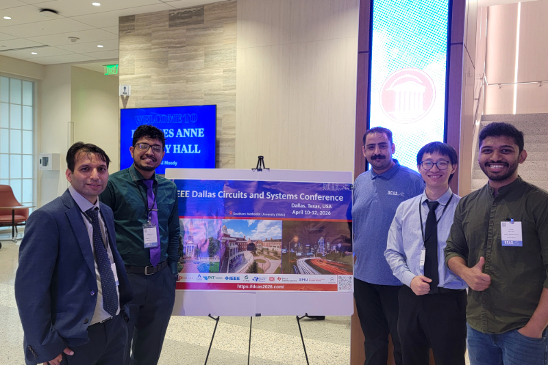 Faculty and students pose beside an IEEE DCAS 2026 conference sign at SMU, highlighting circuits, systems and emerging technologies.