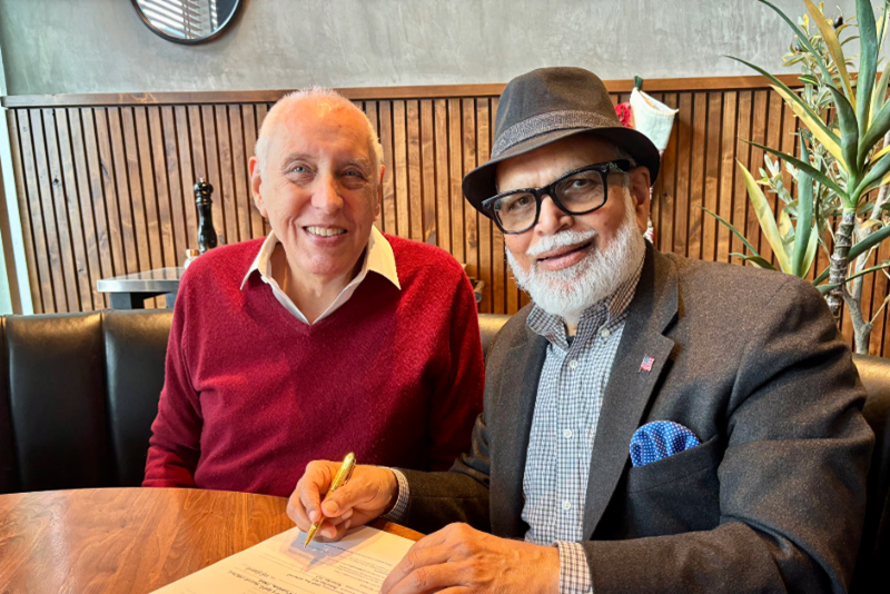 Dr. Barr and Dr. Singh sign the certificate together