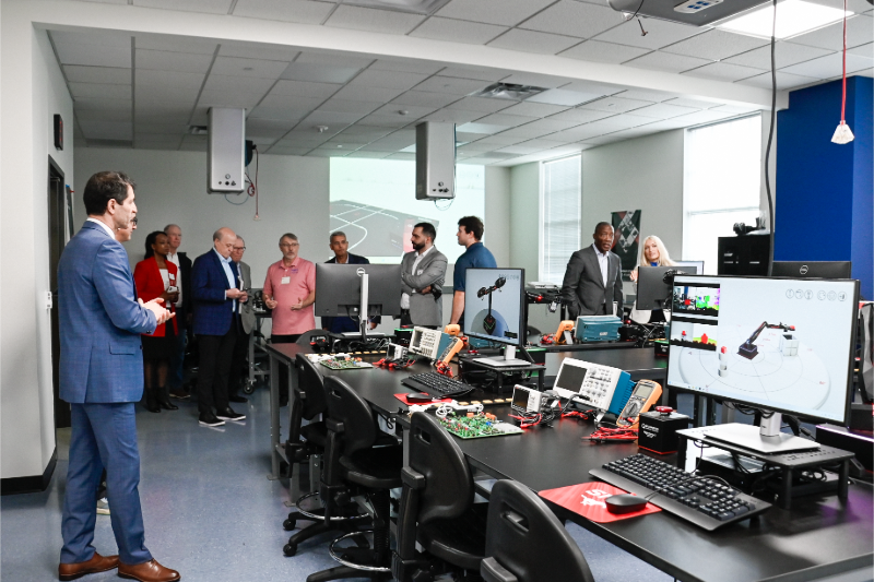 Dean Jalili stands with guests as SMU Lyle faculty member Edmond Richer explains lab equipment during the grand opening celebration.