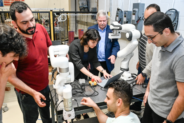Students gather around a robot as the learn in class at SMU Lyle School of Engineering 