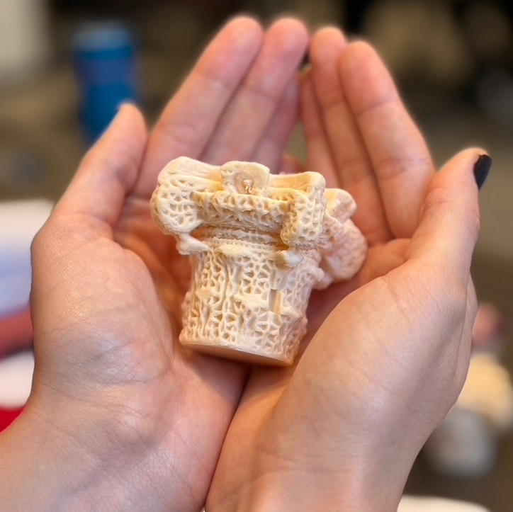Replica of Madinat al-Zahra pillar held in hands at SMU Meadows. Photo by Cristina Aldrich. 