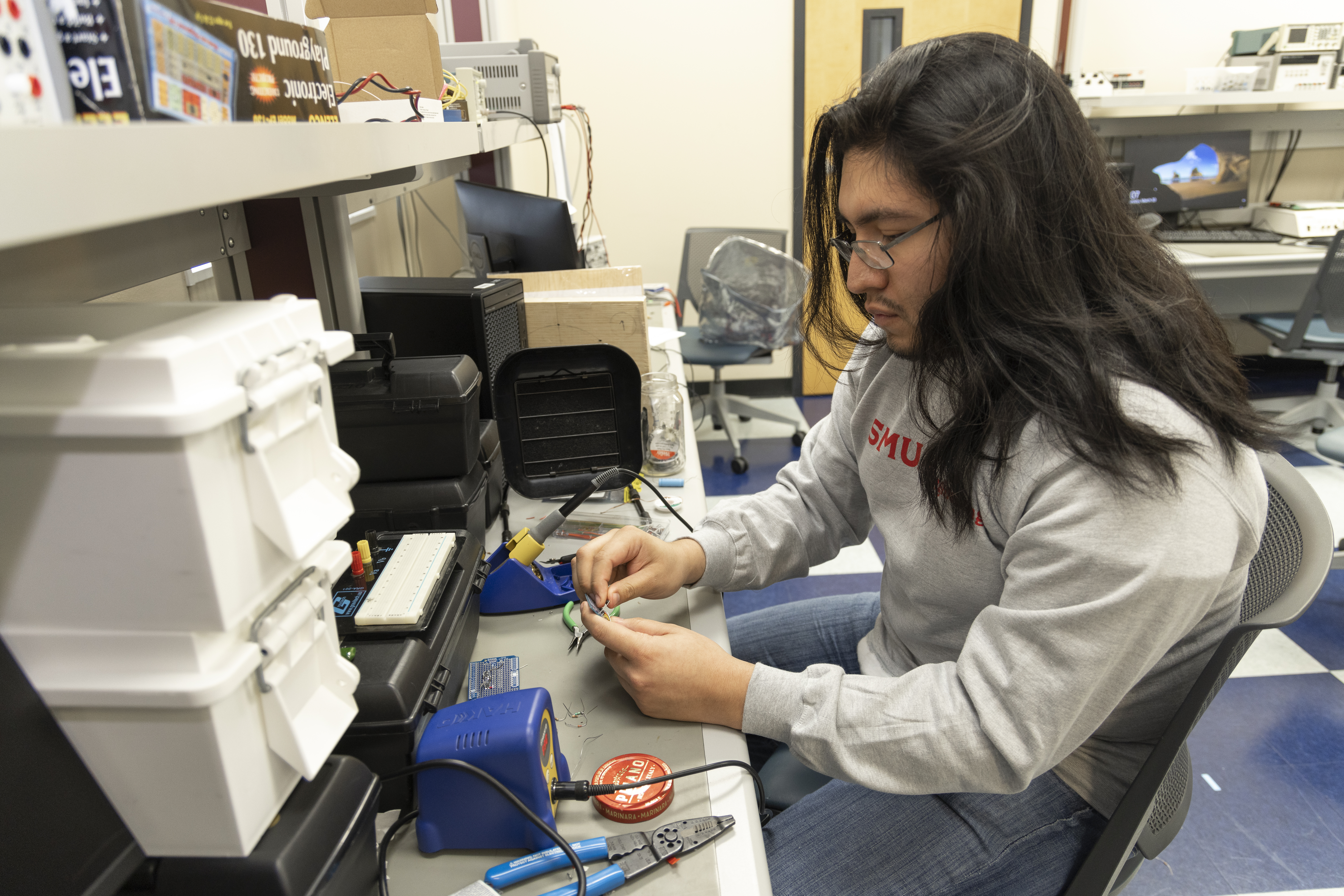 SMU Student engaged in practical lab work.