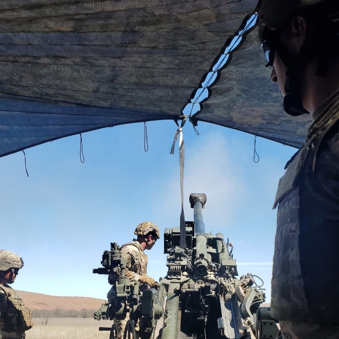 A USA army group stand around equipment