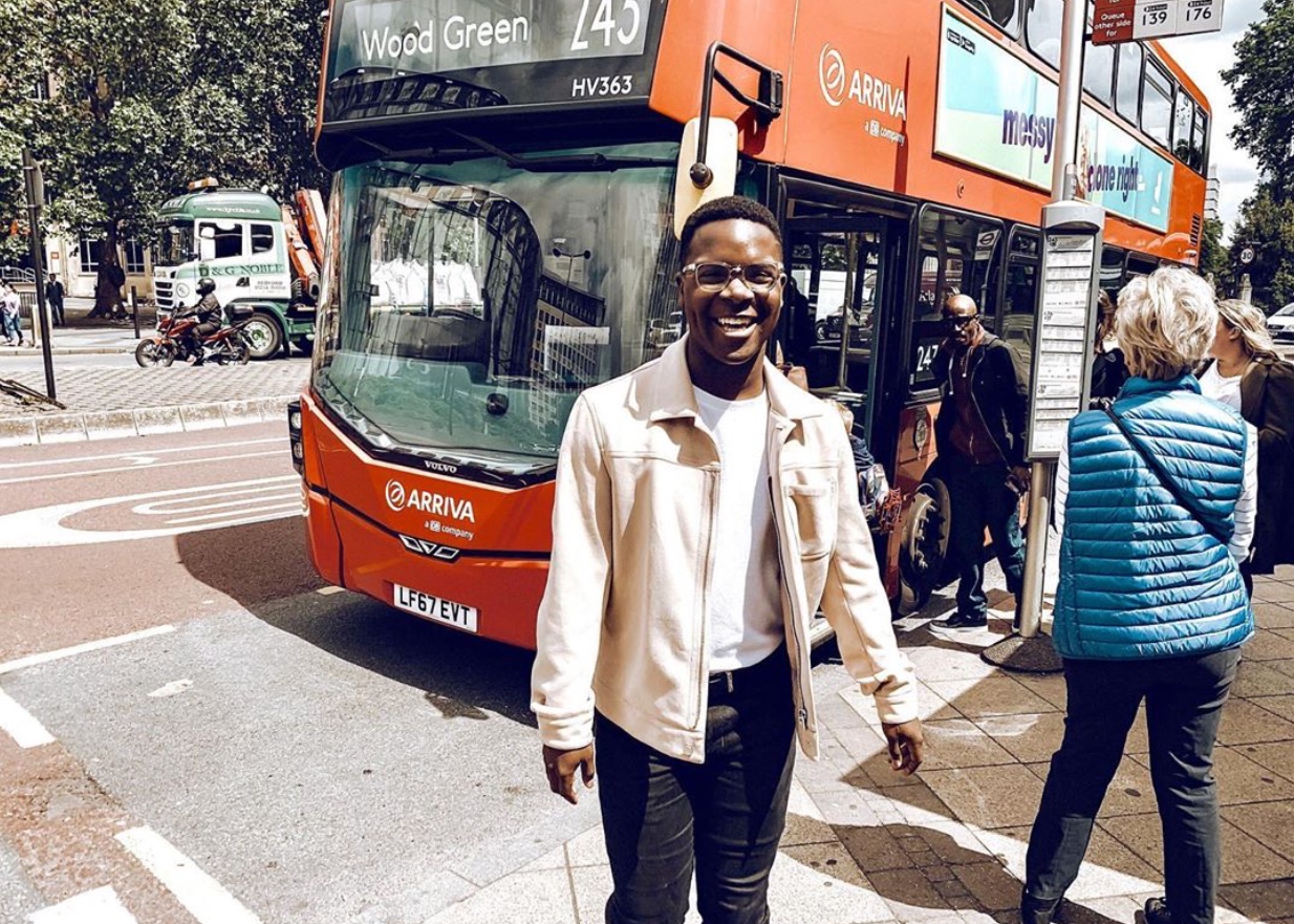 student in front of bus
