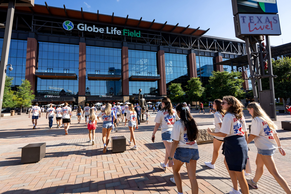 Students walking in to Globe Life Field to see the Texas Rangers play.