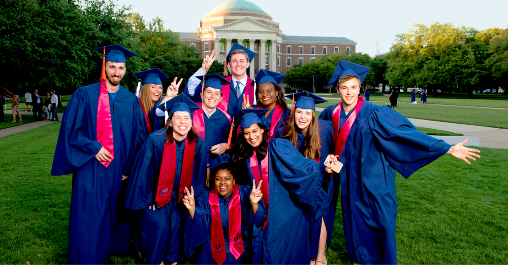 graduates posing on the Dallas Hall lawn