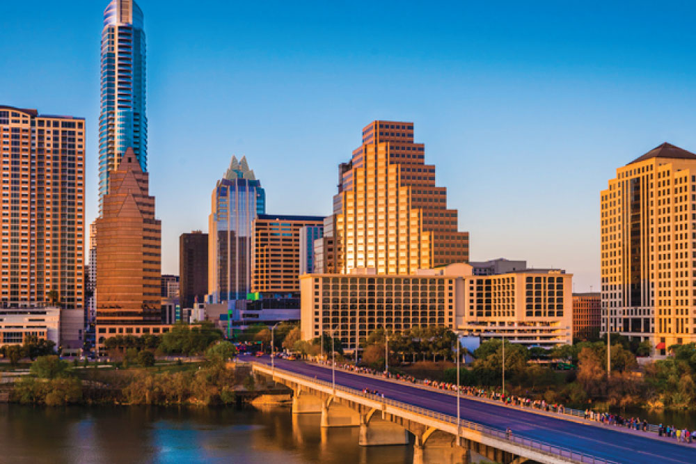 Austin skyline at dusk with Lady Bird Lake and downtown high‑rises.