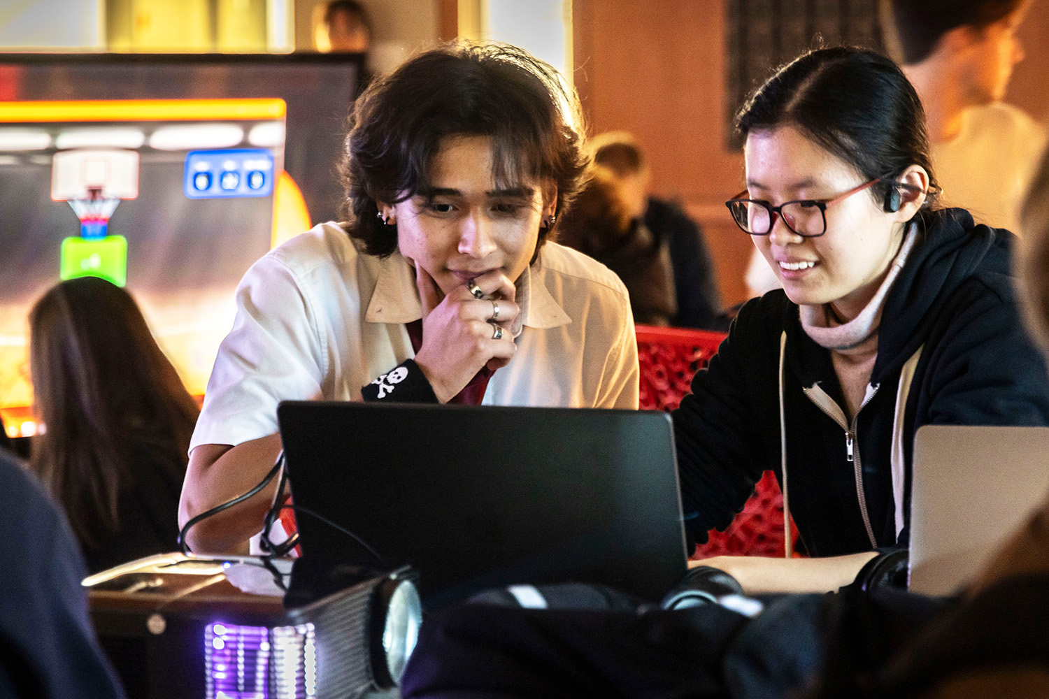 Students sitting in front of a laptop