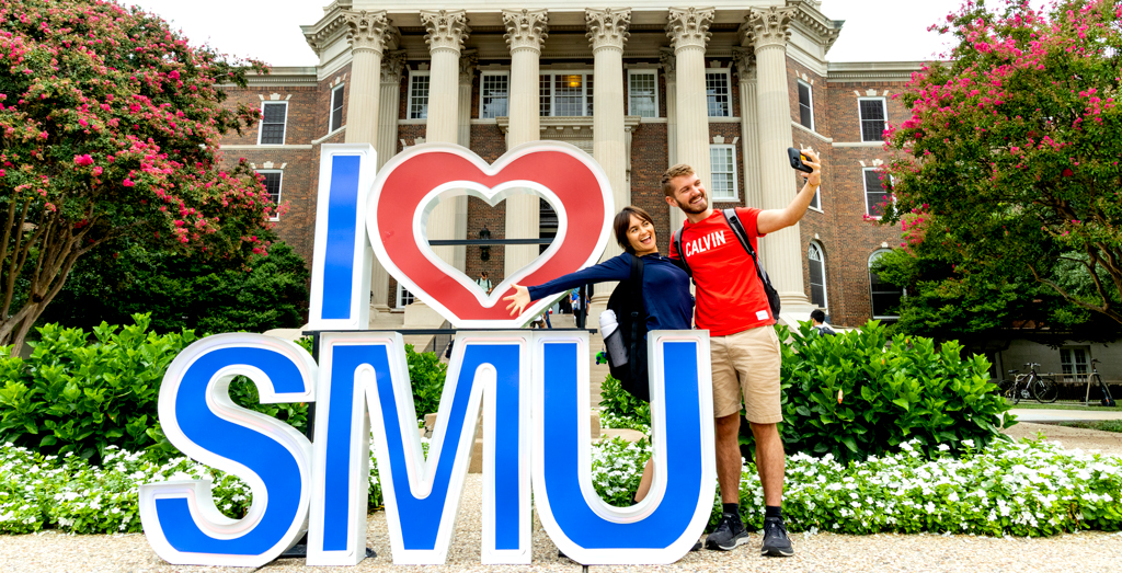 Students taking a selfie by an I Love SMU sign