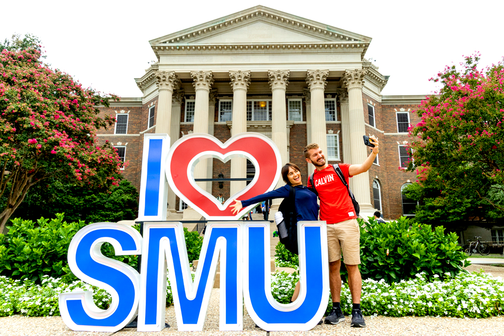 Students taking a selfie in front of an I love SMU sign.