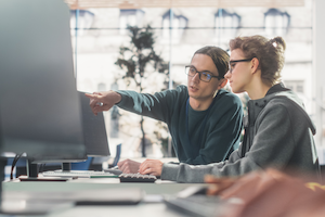 Two students working on AI bootcamp projects