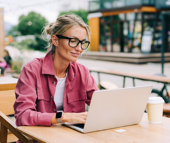 Woman on Laptop at Cafe